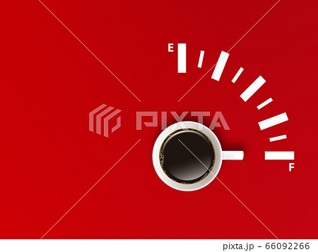 White cup coffee pointing to fully gauge scale on red background. 66092266