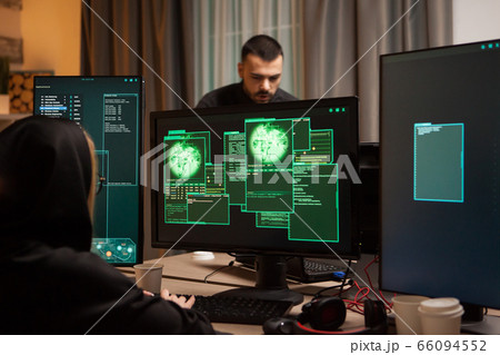 Back view of female hacker writing a malicious malware 66094552