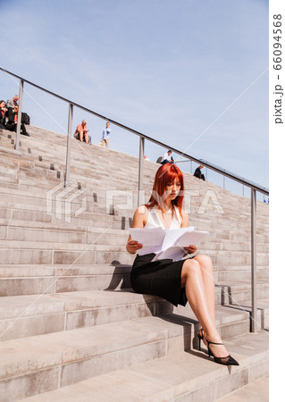 Young redhead business woman in formal outside 66094568