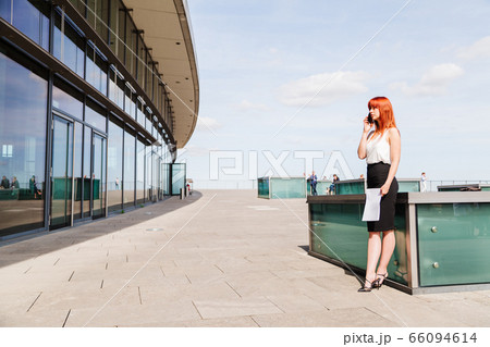 Woman office employee talking on phone outdoor Woman office employee talking on phone outdoor 66094614