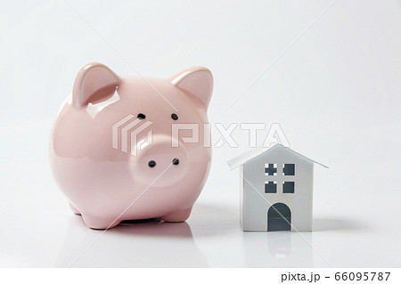 Miniature white toy house and piggy bank on white 66095787