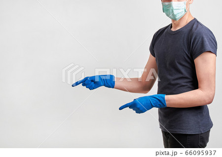 Man in a protective medical face mask and gloves 66095937