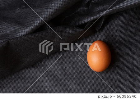 Egg on black fabric background Egg on black fabric background 66096540