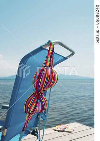 bikini drying on a deck chair on a pier 66098240