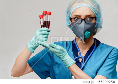 medical doctor nurse woman wearing protective mask and gloves - holding virus blood test tube 66099250