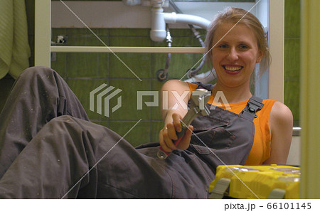 Happy woman with the wrench in her hands 66101145