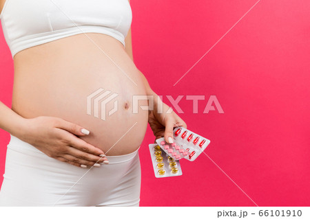 Close up of pregnant woman holding different Close up of pregnant woman holding different 66101910