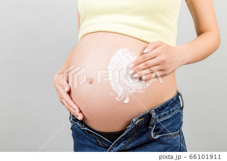 Close up of pregnant woman in unzipped jeans Close up of pregnant woman in unzipped jeans 66101911