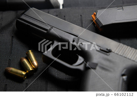 Handgun with bullets on bullet proof vest texture Handgun with bullets on bullet proof vest texture 66102112
