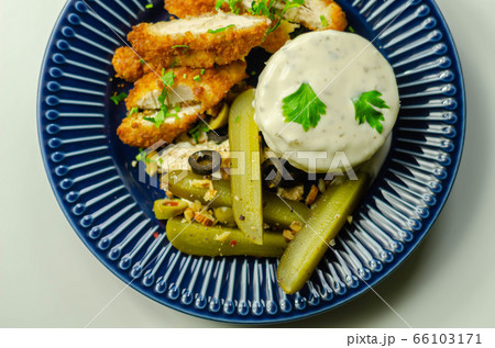 Breaded chicken breast fillet served with mashed  66103171