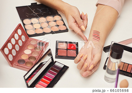 Woman doing a review on cosmetics Woman doing a review on cosmetics 66105698