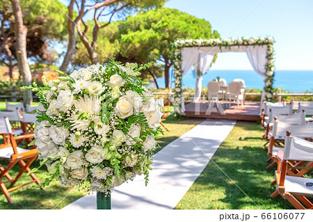 Wedding ceremony on a beautiful green lawn by the ocean. 66106077
