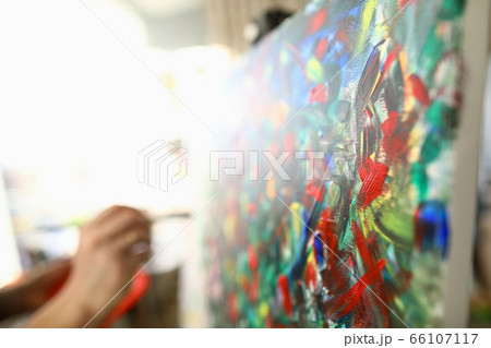 Man paints large bright abstract painting picture Man paints large bright abstract painting picture 66107117