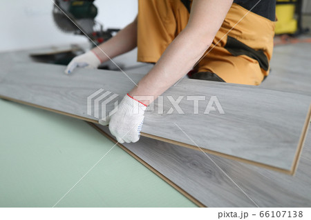 Repairman replaces laminate panels floor apartment 66107138