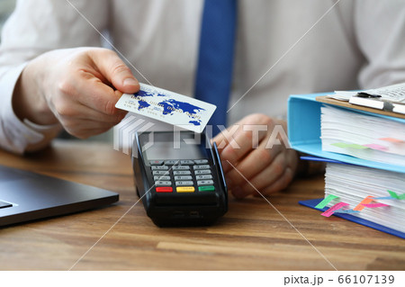 Office employee shows credit card and terminal 66107139
