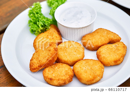 A plate of chicken nuggets on a table 66110717