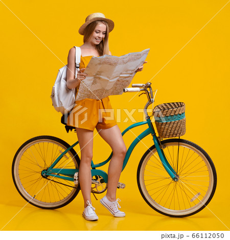 Happy Teen Girl Looking At City Map Next To Vintage Bike Happy Teen Girl Looking At City Map Next To Vintage Bike 66112050