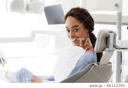 Happy black girl attenting modern dental clinic Happy black girl attenting modern dental clinic 66112205