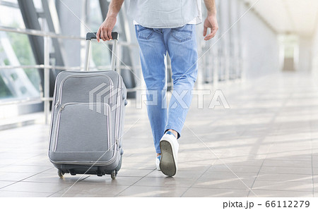 Unrecognizable Man Walking With Suitcase In Airport, Going To Boarding Gate Unrecognizable Man Walking With Suitcase In Airport, Going To Boarding Gate 66112279