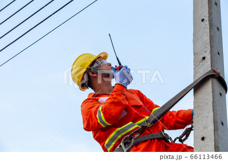Uniformed electricians work on high-rise Uniformed electricians work on high-rise 66113466