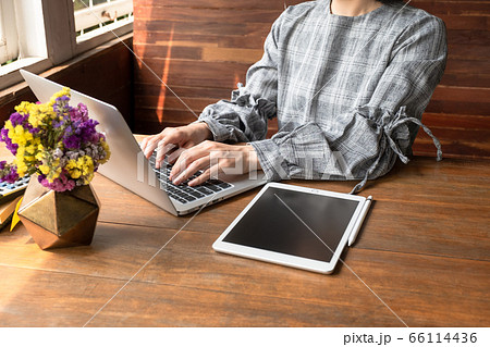 Business woman working at home with her laptop and tablet Business woman working at home with her laptop and tablet 66114436
