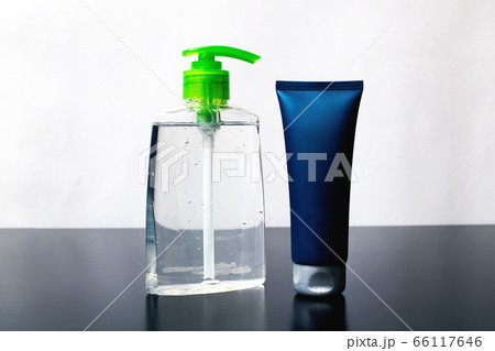 Closed tube with cream and bottle soap on wooden 66117646