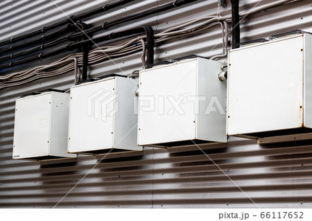 Metal boxes on the wall of a building 66117652