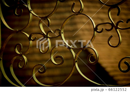 Detail of a wrought iron fence. Detail of a wrought iron fence. 66122552