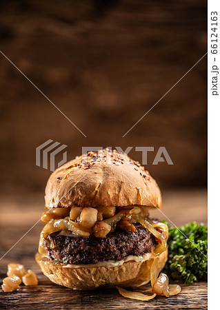 Beef burger with melted cheese, caramelized onions 66124163