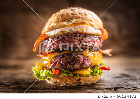 Detail of a massive double beef burger with fried Detail of a massive double beef burger with fried 66124172