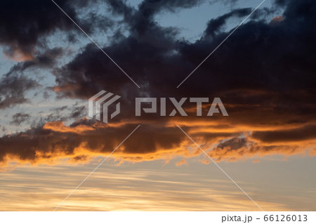 dark clouds on the blue sky and the pink light dark clouds on the blue sky and the pink light 66126013