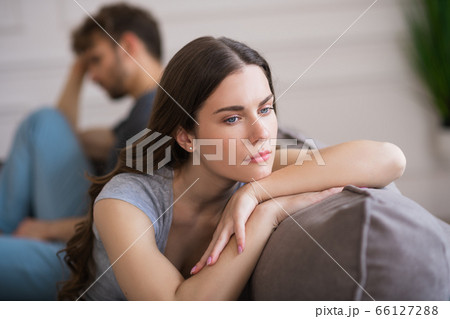 Young woman sit looking upset after a bad talk with her husband Young woman sit looking upset after a bad talk with her husband 66127288