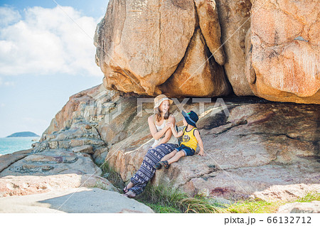 Mother and son travelers at the Hon Chong cape, Garden stone, popular tourist destinations at Nha Trang. Vietnam Mother and son travelers at the Hon Chong cape, Garden stone, popular tourist destinations at Nha Trang. Vietnam 66132712