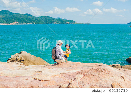 Father and son travelers at the Hon Chong cape, Garden stone, popular tourist destinations at Nha Trang. Vietnam 66132759