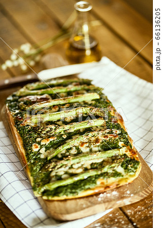 homemade pizza with asparagus and spinach on a rustic wooden table homemade pizza with asparagus and spinach on a rustic wooden table 66136205
