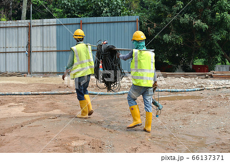 JOHOR, MALAYSIA -JUNE 17, 2016: Construction workers walking in the construction site. Wearing proper PPE for their safety.  66137371