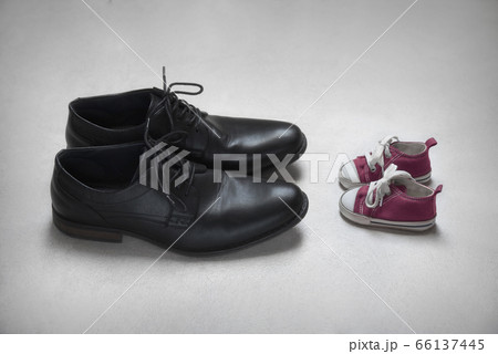 Father with Child Metaphor, baby and adult shoes  66137445