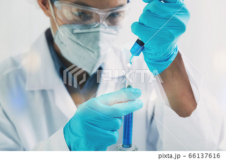 Researcher or scientists loads liquid sample into test tube. Researcher or scientists loads liquid sample into test tube. 66137616