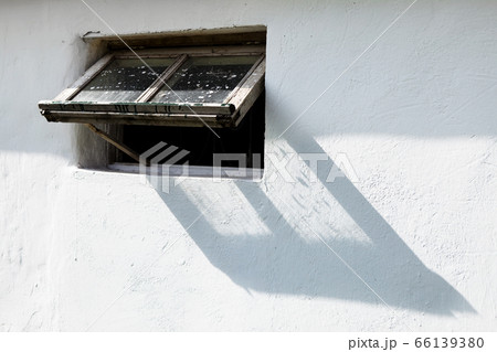 White wall and wooden window frame, stable 66139380