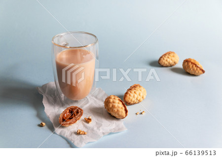 Hot coffee with milk and cookies on a blue background Hot coffee with milk and cookies on a blue background 66139513