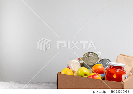 Food donations or food delivery concept. Healthy natural food, fruits, cereals and canned food on gray table 66139548