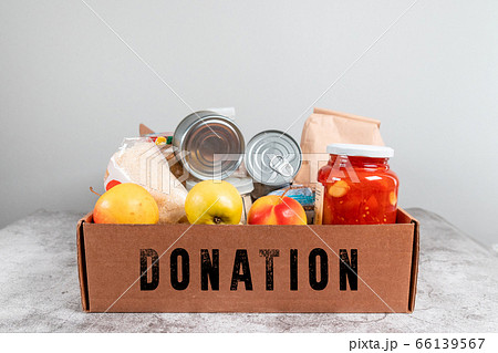 Various canned food, flour, fruit and cereals in a cardboard box. food donations or food delivery concept. Various canned food, flour, fruit and cereals in a cardboard box. food donations or food delivery concept. 66139567