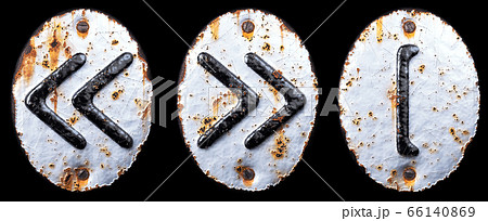 Set of symbols left and right pointing double angle quotation mark, left square bracket made of forged metal on the background fragment of a metal surface with cracked rust. Set of symbols left and right pointing double angle quotation mark, left square bracket made of forged metal on the background fragment of a metal surface with cracked rust. 66140869