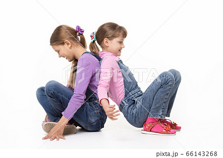 Children sitting on the floor have fun pushing Children sitting on the floor have fun pushing 66143268