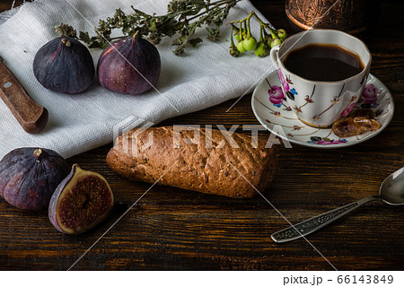 Light coffee break with multicereal bun and few ripe figs. Light coffee break with multicereal bun and few ripe figs. 66143849