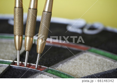 Three darts on triple ring target of dartboard, 66146342