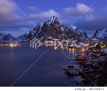 Illuminated fishing village with rorbu houses in Reine, Lofoten island, Norway Illuminated fishing village with rorbu houses in Reine, Lofoten island, Norway 66146871