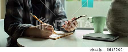 Female freelancer sitting decide window and noting Female freelancer sitting decide window and noting 66152094