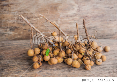 Longan Fresh Dimocarpus longan. A bunch of Longan and Peel show the white meat with black seed was placed on a wooden background Longan Fresh Dimocarpus longan. A bunch of Longan and Peel show the white meat with black seed was placed on a wooden background 66153315