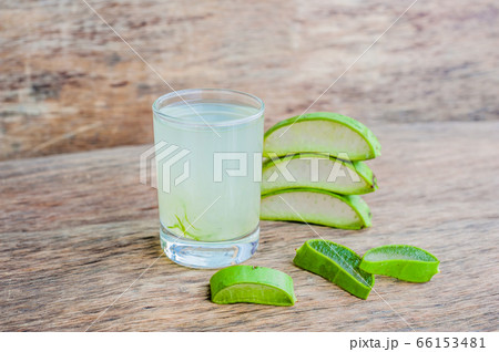 Aloe vera pieces and aloe gel in the glass on an old dark wood background Organic cosmetics concept Aloe vera pieces and aloe gel in the glass on an old dark wood background Organic cosmetics concept 66153481
